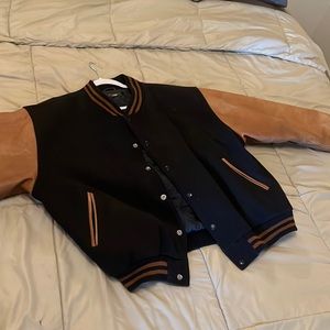 dark blue and leather varsity jacket